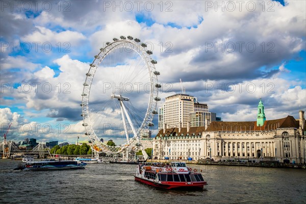 View across the Thames to the London Eye Ferris Wheel and County Hall