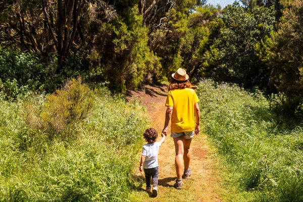 A mother with her son walking on the La Llania trekking trail in El Hierro