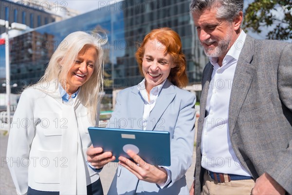 Group executives or businessmen and businesswoman in a business area. Chatting at work break