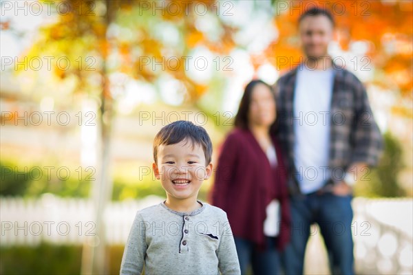 Outdoor portrait of multiethnic chinese and caucasian family