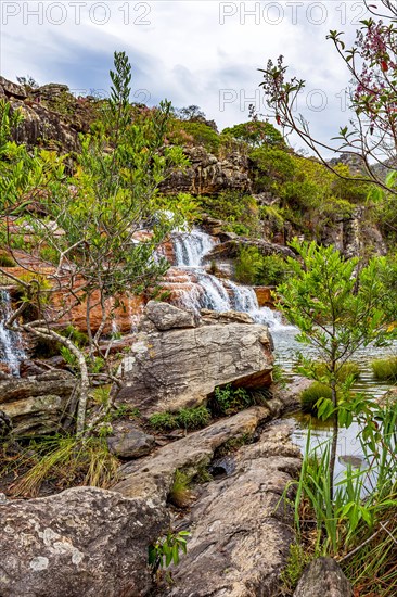 Set of clear water cascades among the rocks and native vegetation of the Biribiri environmental reserve in Diamantina