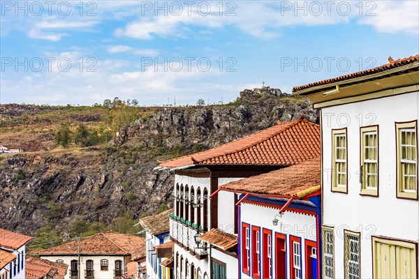 View of colonial style houses facade and mountains in the background on Diamantina city