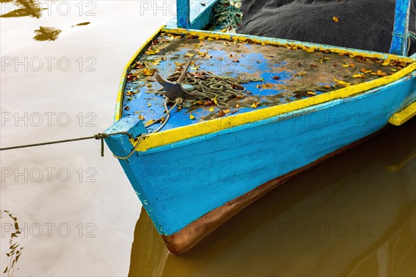 Rustic wooden fishing boat over the waters of the Paraty channel