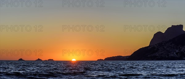 Sunset over the sea at Ipanema beach in Rio de Janeiro city during summer