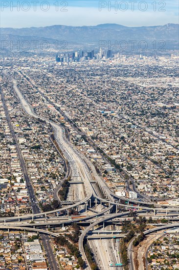 Aerial view of Harbor interchange and Century Freeway traffic with downtown Los Angeles