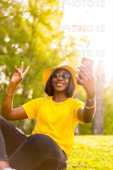 Adventure Awaits: Young Black Tourist Woman Snapping a Selfie in the Woods