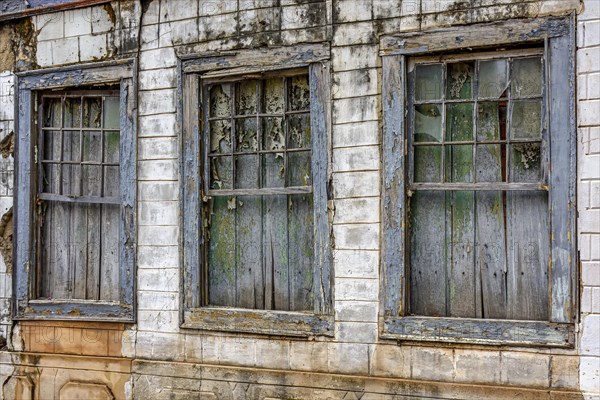 Old wooden windows ruined by time on the facade of abandoned house in the historic city of Diamantina in Minas Gerais
