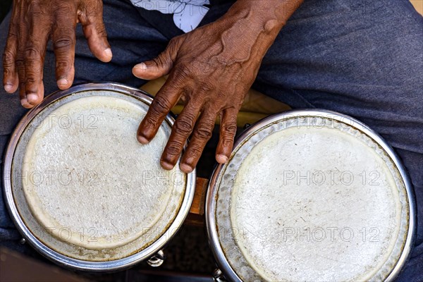 Hands and istrument of musician playing bongo in the streets of Pelourinho in Salvador in Bahia