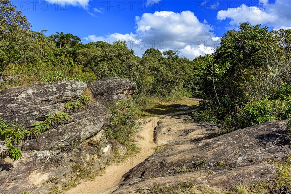 Trail through the rocks and vegetation used for expeditions in the hills around the city of Lavras Novas in Minas Gerais