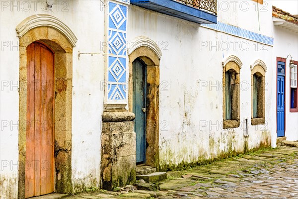 House facade in weather-damaged colonial architecture on cobblestone street in the historic city of Paraty in the state of Rio de Janeiro