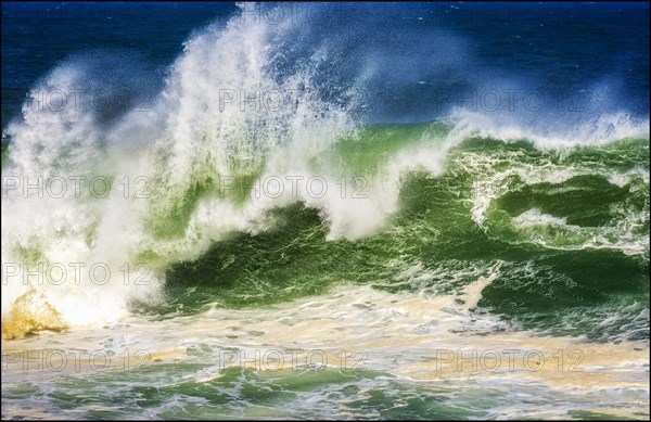 Wave crashing during stormy weather on a sunny day at the beaches of Rio de Janeiro