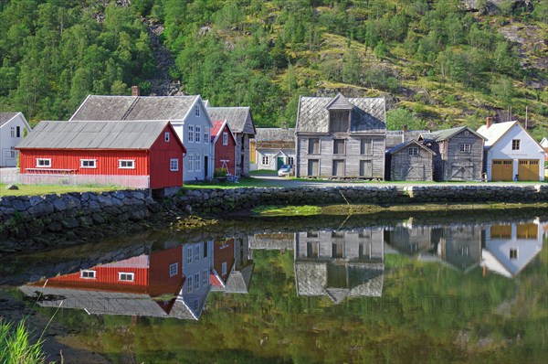 Wooden houses reflected in calm waters