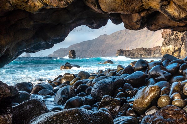 Natural arch of stones next to the La Maceta rock pool on the island of El Hierro in the Canary Islands