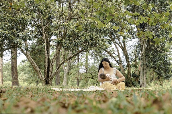 The mother is breastfeeding her daughter. Moment of motherhood