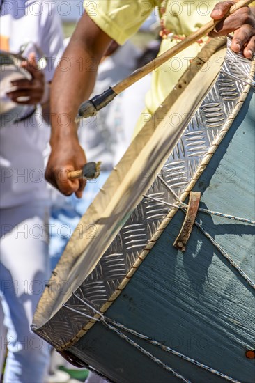 Drum being played and lit by the sun during Brazilian Carnival