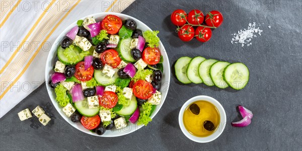 Greek salad with fresh tomatoes olives and feta cheese healthy eating food from above on slate banner in Stuttgart