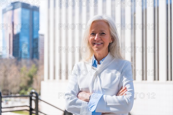 Portrait of executive professional senior woman in a business area