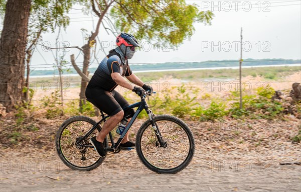 Lifestyle of a chubby cyclist on the road. Professional cyclist on a dirt road