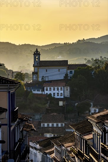Old church seen in the city of Ouro Preto during sunset with its houses in colonial architecture