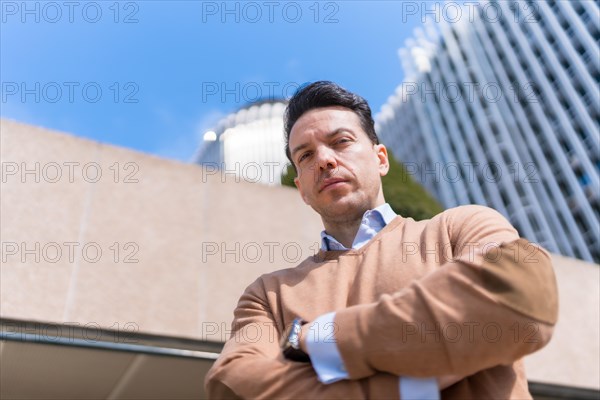 Middle aged male entrepreneur in a business area looking at camera