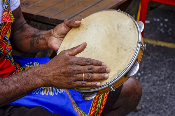 Percussionist playing tambourine in the famous streets of Pelourinho district in city of Salvador