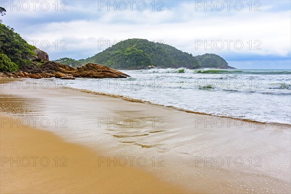 Deserted beach during rainy day with clouds in Trindade