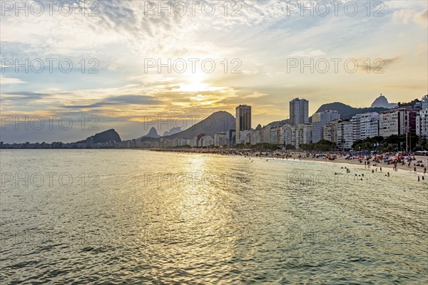 Sunset on the famous Copacabana beach with the sea