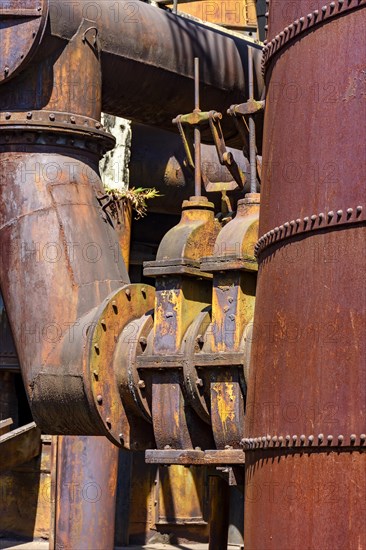 Corroded and rusty gears and piping from old machinery for processing iron ore in Minas Gerais