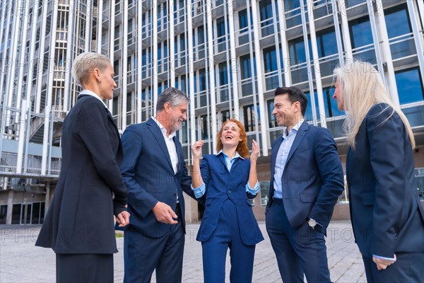 Group of Adult Executives Laughing and Chatting in a Business District
