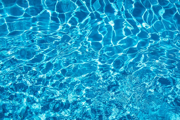 Wavy blue water surface with reflections