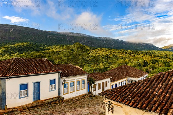 View of the old historic city of Tiradentes with its historic colonial-style houses and mountains in the background during the afternoon in Minas Gerais