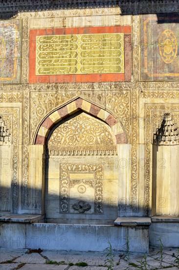 Ol and historic muslim portal with washbasin and arabesques in Istanbul