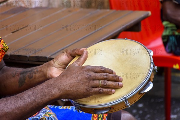 Brazilian samba performance with musician playing tambourine in the streets of Pelourinho