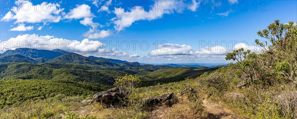 Panoramic image of the mountain ranges with their rocks and vegetation and typical forests of the state of Minas Gerais in Brazil on a sunny day