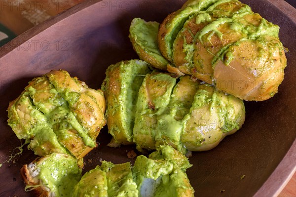 Garlic bread appetizer with melted cheese and fine aromatic herbs roasted on the barbecue grill