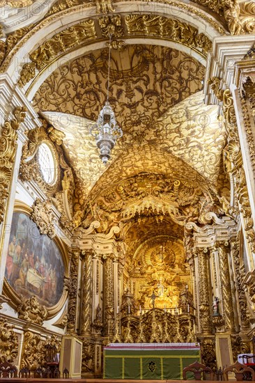 Interior and altar of a brazilian historic ancient church from the 18th century in baroque architecture with details of the walls in gold leaf in the city of Tiradentes