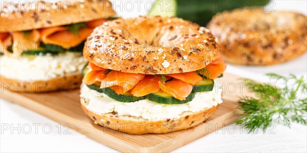 Bagel sandwich for breakfast topped with salmon fish on a board Panorama in Stuttgart