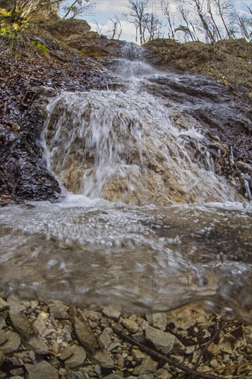 Underwater photo of a mountain stream with waterfall in the Kalkalpen National Park