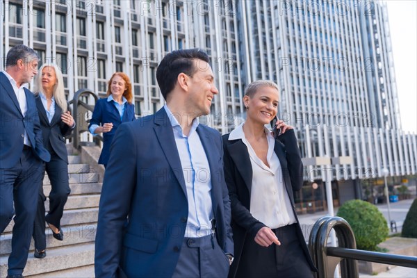 Senior Executives Exchange Ideas While Descending Stairs in Business District