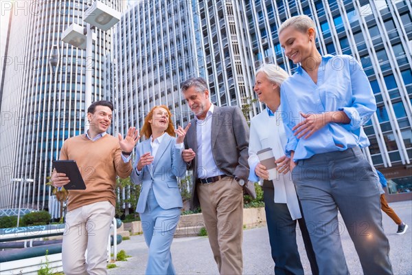 Group of coworkers walking going to work outdoors in a corporate office area