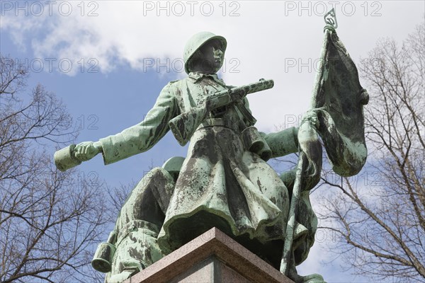 Soviet soldier with weapon and flag