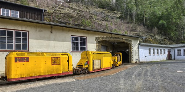 Miners' transportation railway entering a mine gallery