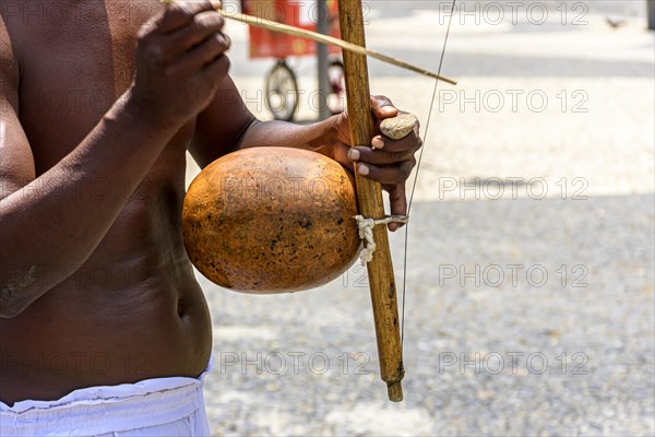 Musicians playing traditional instruments used in capoeira