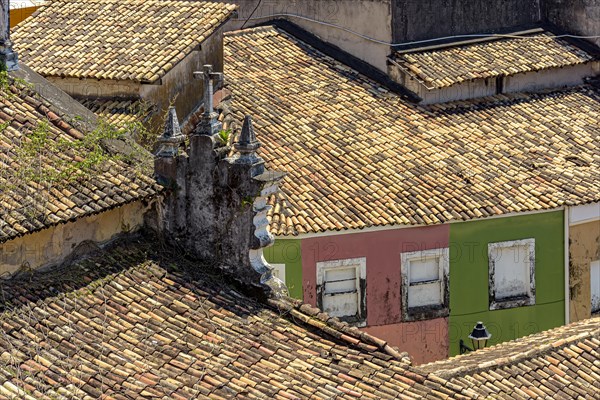 Roofs of old colonial-style houses and churches seen from above and worn by time in the Pelourinho neighborhood of Salvador