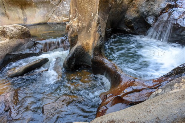 Small creek with clear waters running through the rocks of the mountains of Minas Gerais