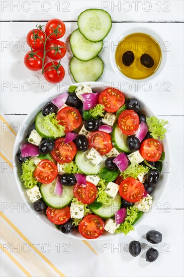 Greek salad with fresh tomatoes olives and feta cheese healthy eating food from above on wooden board in Stuttgart