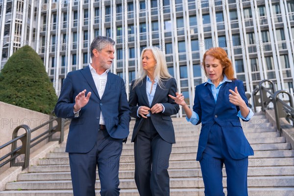 Senior Executives Discuss Plans While Going Down Stairs in Commercial Building