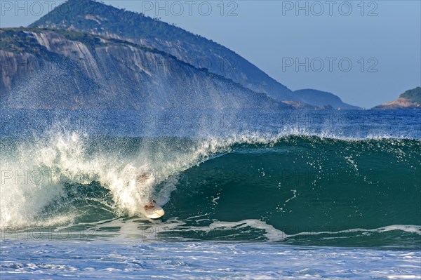Surfer inside the tube in a wave at Ipanema beach