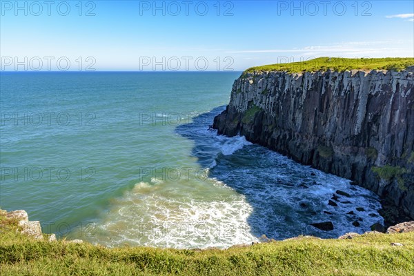 Guarita stone in the city of Torres in Rio Grande do Sul with its cliffs ending in the sea with waves and horizon