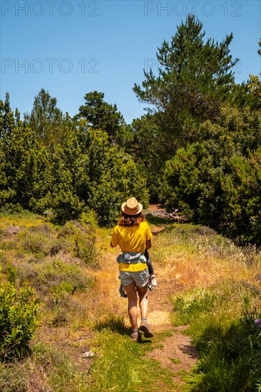 A mother with her son holding her son in her arms on the La Llania hiking trail in El Hierro